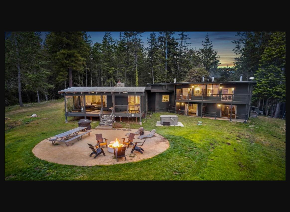 Driftwood Lodge exterior at twilight with fire pit